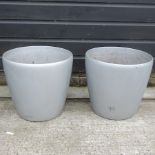 A pair of silver coloured garden pots,
