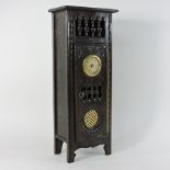 An early 20th century oak miniature cabinet, inset with a clock,