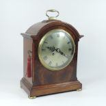 An early 20th century mahogany bracket clock, the silvered dial showing Roman numerals,