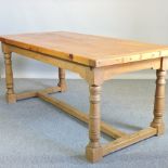 A pine refectory table, with a stretcher base,