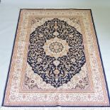 A Keshan style rug, with a central medallion and foliate design, on a blue ground,
