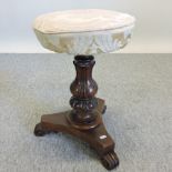 A Victorian mahogany revolving piano stool