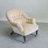 A cream upholstered button back armchair,
