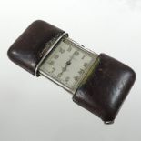 An early 20th century Movado silver purse watch, the square dial showing Arabic numerals,