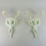 A pair of 19th century Minton white glazed porcelain wall brackets, each in the form of a putti,