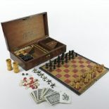 A Victorian games compendium, fitted with various games to include chess, cribbage, bone dominoes,