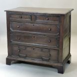 An 18th century oak chest, containing two short over three long drawers, with geometric moulding,