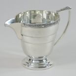 An Art Deco silver cream jug, of stepped pedestal shape, Birmingham 1937,