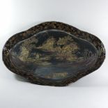 An 18th century oriental black lacquered serving tray, of scalloped oval shape,