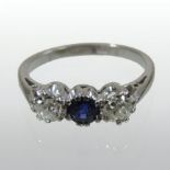 An 18 carat white gold sapphire and diamond three stone ring