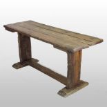 A 19th century stained pine refectory table, of small proportions, the plank top,