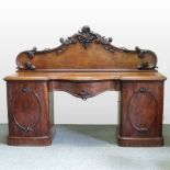 A William IV carved mahogany pedestal sideboard, of serpentine shape,