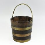 A 19th century brass bound coopered wooden peat bucket, with a swing handle,