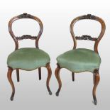 A set of six Victorian carved walnut balloon back dining chairs, with green upholstered seats,