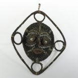 A shell and woven tribal spirit mask, from Papua New Guinea,