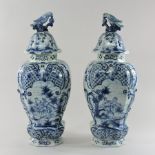 A pair of large 19th century Dutch delft blue and white vases and covers,