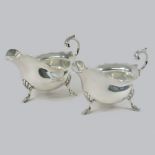 A pair of early 20th century silver sauce boats, each of helmet shape, by Walker and Hall,