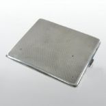 An Edwardian silver cigarette case, of hinged rectangular shape, with engine turned decoration,