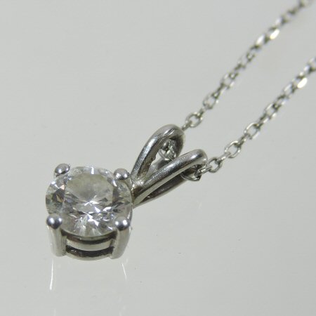 A diamond solitaire pendant, approximately 0.