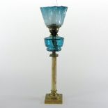 A late 19th century brass mounted onyx oil lamp, in the form of a column, with a blue glass shade,