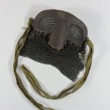 A World War I chain mail and leather tank 'spatter' mask, with an adjustable strap,