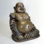 A large bronze figure of a seated Chinese Buddha, with legs crossed,