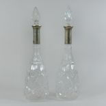 A pair of German cut glass and white metal mounted decanters and stoppers,