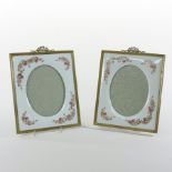 A pair of early 20th century continental porcelain photograph frames, decorated with flowers,