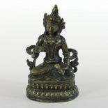 A South East Asian bronze figure of a seated deity, on an oval base,