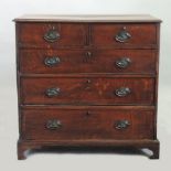 A George III oak chest, containing two short over three long graduated drawers, on bracket feet,