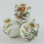 An early 20th century Worcester style porcelain cluster vase, painted with birds,