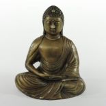 A bronze figure of a Thai Buddha, shown seated wearing robes,