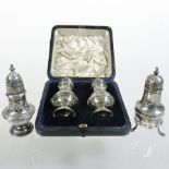 A pair of Edwardian silver peppers, London 1902, cased,