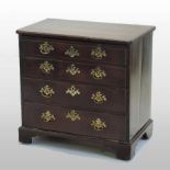 A good George III mahogany bachelor's chest, the shaped top with ebony stringing,