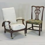 A Victorian mahogany and cream upholstered reclining armchair, with loose cushions,
