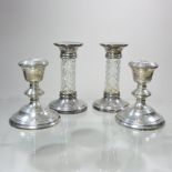 A pair of modern silver mounted glass table candlesticks, with facet cut columns, 15cm high,