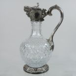 A modern silver mounted glass claret jug, the hinged lid with a scrolled thumbpiece,