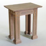 An Arts and Crafts light oak hall table, of geometric design, on square legs,