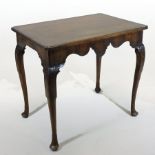 An 18th century Irish mahogany side table, with shaped top and apron, standing on cabriole legs,