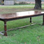 A 17th century style oak refectory table, on turned legs and stretcher base,