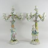 A pair of Meissen style floral encrusted porcelain candelabra,