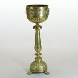 A late 19th century brass jardiniere on stand, with relief decoration,