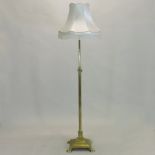 An early 20th century brass telescopic standard lamp and shade, in the form of a Corinthian column,