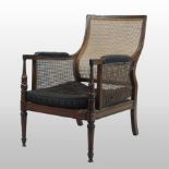 A 19th century mahogany single cane bergere armchair, with padded arms and a cushion seat,