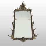 A large 19th century black forest antler framed wall mirror, of rectangular shape,