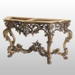 An ornate 19th century Italian carved and gilt wood console table base, of serpentine form,