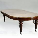 A Victorian mahogany wind out oval extending dining table, on fluted legs and castors,