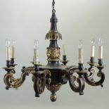 A carved wooden and gilt painted eight branch chandelier, with scrolled decoration, 91cm diameter,