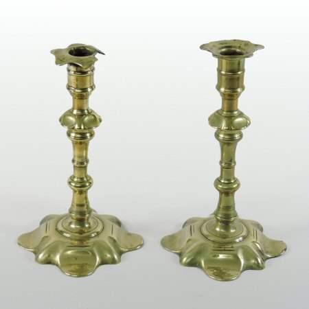 A pair of 18th century brass candlesticks, with petal shaped bases,