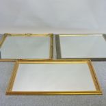 A gilt framed wall mirror, with relief decoration, 134 x 104cm,
